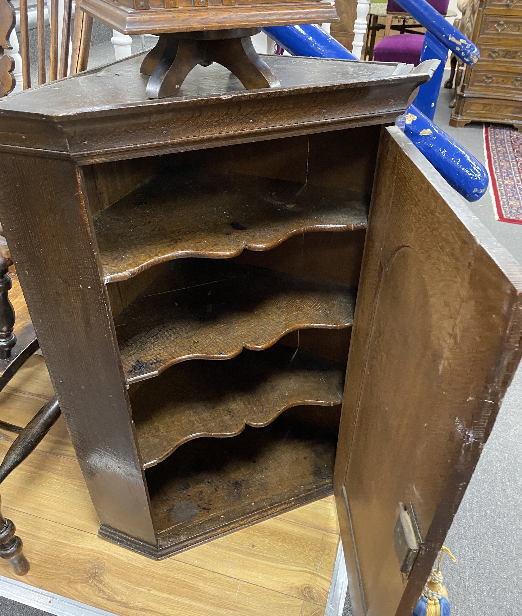 A George III oak hanging corner cupboard, width 69cm, depth 45cm, height 91cm